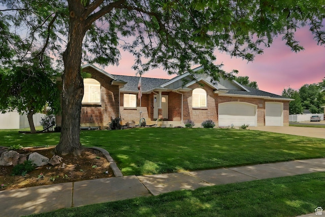774 W 2300 S, Syracuse, UT 84075 - ranch-style house with driveway, an attached garage, brick siding, and a yard