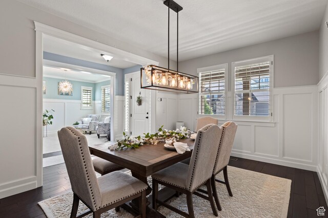 5284 W Orchard Spring Dr S, Herriman, UT 84096 - dining room with a decorative wall, dark wood-style flooring, a wainscoted wall, and a chandelier