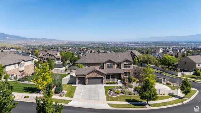 5284 W Orchard Spring Dr S, Herriman, UT 84096 - view of front facade featuring a residential view, concrete driveway, stone siding, and a mountain view