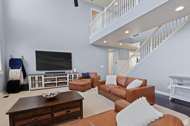 5284 W Orchard Spring Dr S, Herriman, UT 84096 - living room with stairs, a towering ceiling, baseboards, ceiling fan, and wood finished floors