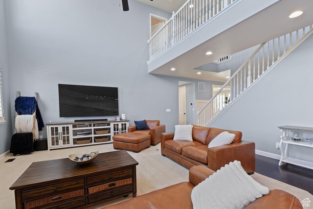 5284 W Orchard Spring Dr S, Herriman, UT 84096 - living room with stairs, a towering ceiling, baseboards, ceiling fan, and wood finished floors