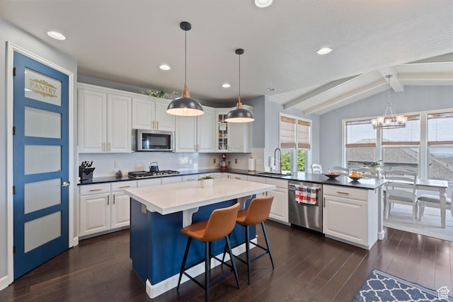 5284 W Orchard Spring Dr S, Herriman, UT 84096 - kitchen featuring a peninsula, appliances with stainless steel finishes, a sink, a chandelier, and dark wood-type flooring
