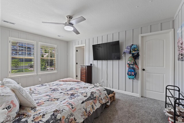 5284 W Orchard Spring Dr S, Herriman, UT 84096 - bedroom featuring carpet flooring, a textured ceiling, a ceiling fan, and a decorative wall