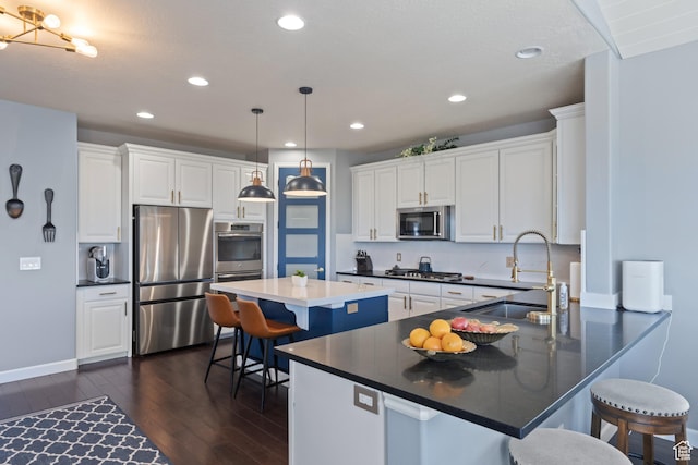 5284 W Orchard Spring Dr S, Herriman, UT 84096 - kitchen featuring appliances with stainless steel finishes, dark wood-style flooring, a sink, a peninsula, and white cabinets