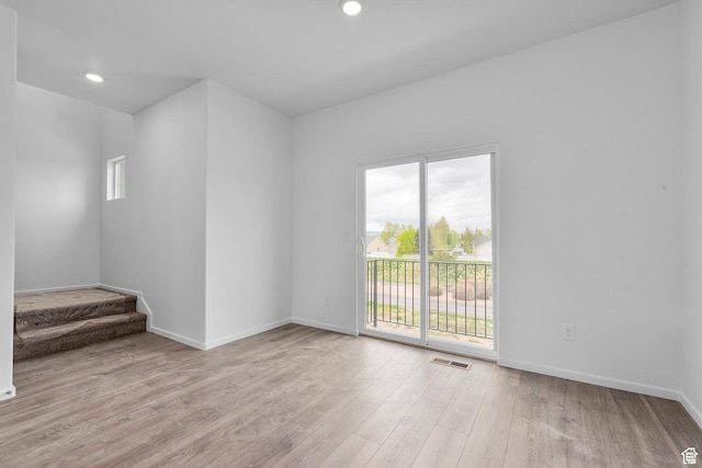 1893 E Thunder Ln Unit 497, Eagle Mountain, UT 84005 - unfurnished room featuring healthy amount of natural light, light wood-type flooring, baseboards, stairway, and recessed lighting