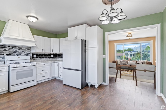 773 W 1280 S, Provo, UT 84601 - kitchen featuring white appliances, custom exhaust hood, white cabinets, decorative backsplash, and dark wood-style flooring