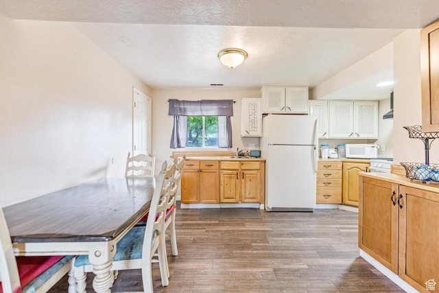 773 W 1280 S, Provo, UT 84601 - kitchen with white appliances, wood finished floors, light countertops, a sink, and wall chimney range hood