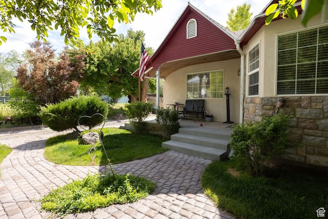 40 S Main St, Glenwood, UT 84730 - property entrance featuring stone siding, stucco siding, and a porch