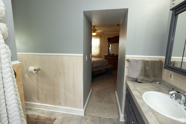 40 S Main St, Glenwood, UT 84730 - ensuite bathroom featuring vanity, ceiling fan, a wainscoted wall, and wood walls