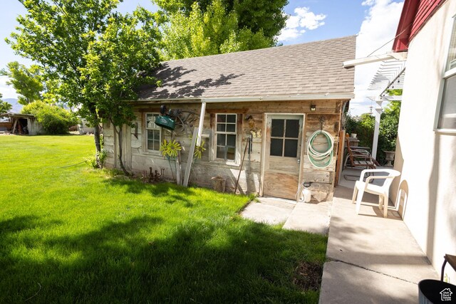 40 S Main St, Glenwood, UT 84730 - view of front of property featuring a shingled roof, a front yard, an outbuilding, and stone siding