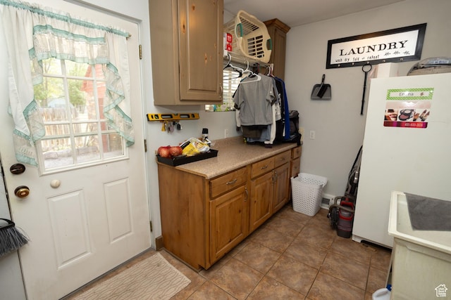 40 S Main St, Glenwood, UT 84730 - kitchen with freestanding refrigerator, light countertops, tile patterned flooring, and brown cabinetry