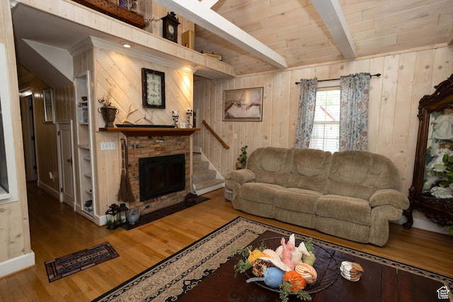 40 S Main St, Glenwood, UT 84730 - living room featuring a fireplace, wood finished floors, wood walls, wooden ceiling with exposed beams, and stairway