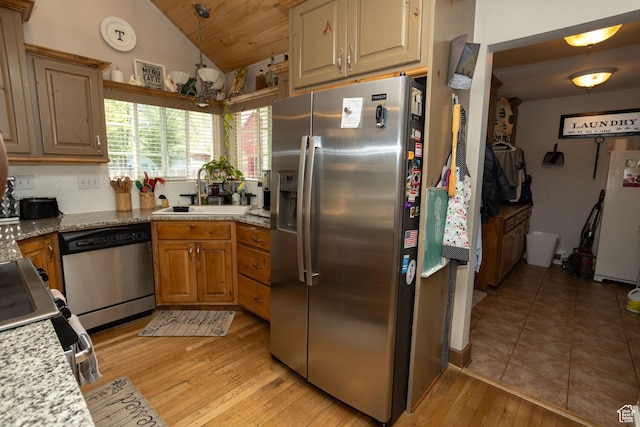 40 S Main St, Glenwood, UT 84730 - kitchen featuring stainless steel appliances, a sink, lofted ceiling, light wood-style flooring, and brown cabinets