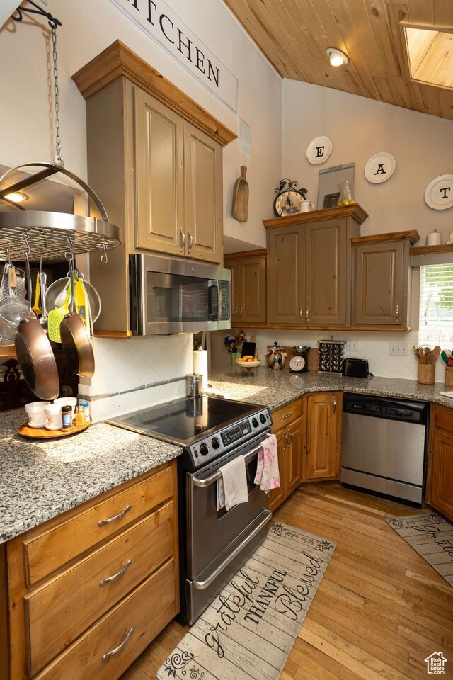 40 S Main St, Glenwood, UT 84730 - kitchen featuring appliances with stainless steel finishes, tasteful backsplash, vaulted ceiling, wooden ceiling, and light wood-style floors