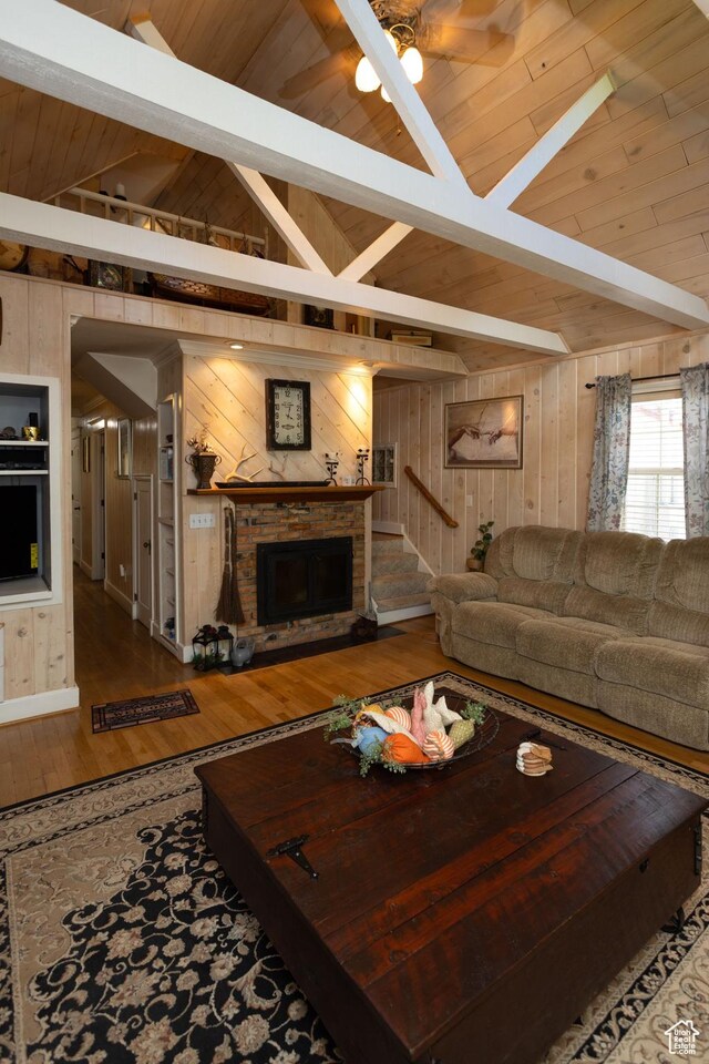 40 S Main St, Glenwood, UT 84730 - living room featuring wood walls, wood ceiling, wood finished floors, a fireplace, and ceiling fan