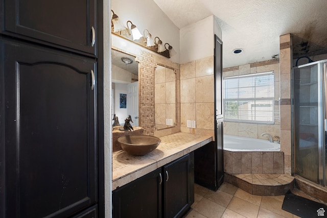 2554 S Chesterfield St W, West Valley City, UT 84119 - full bathroom with vanity, a stall shower, a bath, tile patterned floors, and a textured ceiling