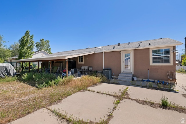 2554 S Chesterfield St W, West Valley City, UT 84119 - rear view of house with stucco siding, central AC, and a patio area