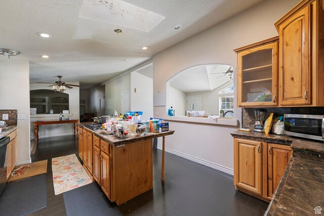 2554 S Chesterfield St W, West Valley City, UT 84119 - kitchen with a ceiling fan, stainless steel microwave, dark wood finished floors, glass insert cabinets, and recessed lighting
