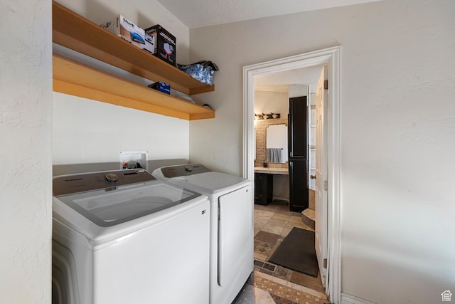 2554 S Chesterfield St W, West Valley City, UT 84119 - laundry area with independent washer and dryer and light stone finish flooring