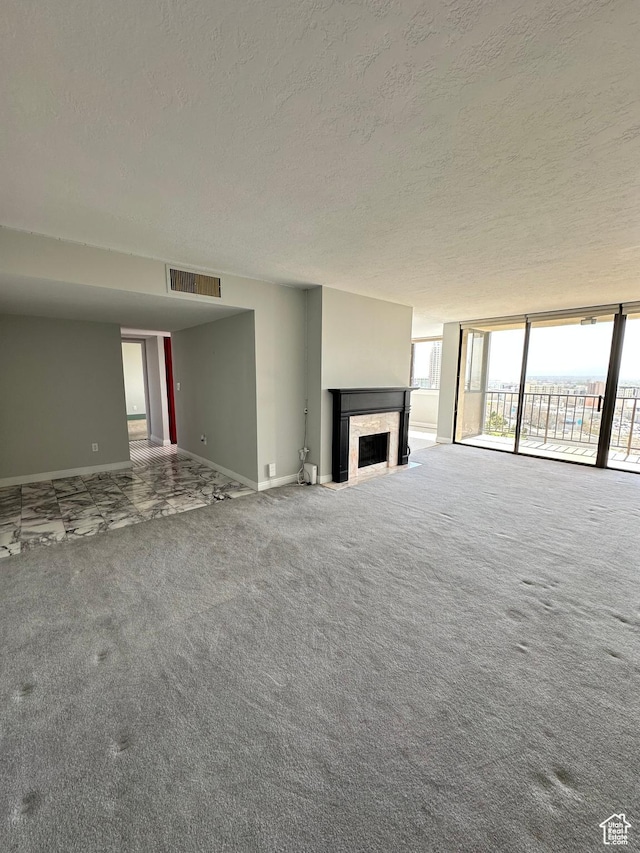 241 N Vine St W Unit 808W, Salt Lake City, UT 84103 - unfurnished living room featuring a textured ceiling, baseboards, a high end fireplace, carpet, and expansive windows