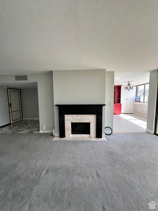 241 N Vine St W Unit 808W, Salt Lake City, UT 84103 - unfurnished living room featuring a textured ceiling, a premium fireplace, carpet, baseboards, and a chandelier