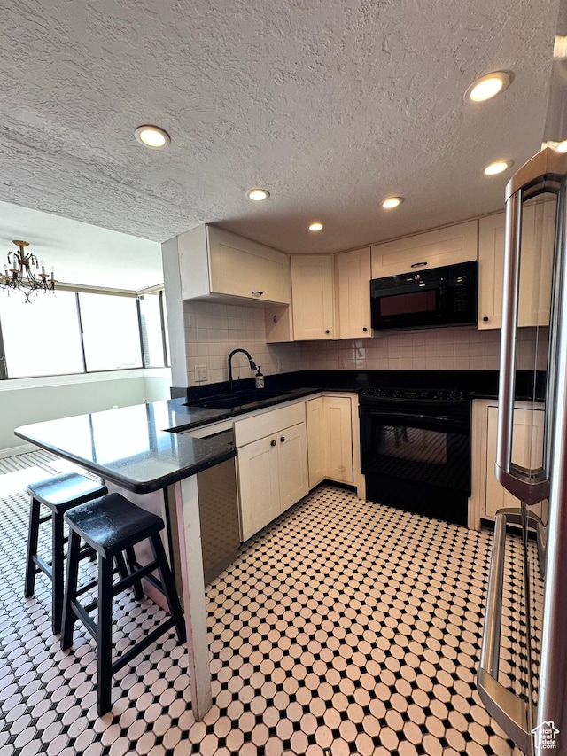 241 N Vine St W Unit 808W, Salt Lake City, UT 84103 - kitchen featuring black appliances, dark countertops, a sink, decorative backsplash, and a textured ceiling