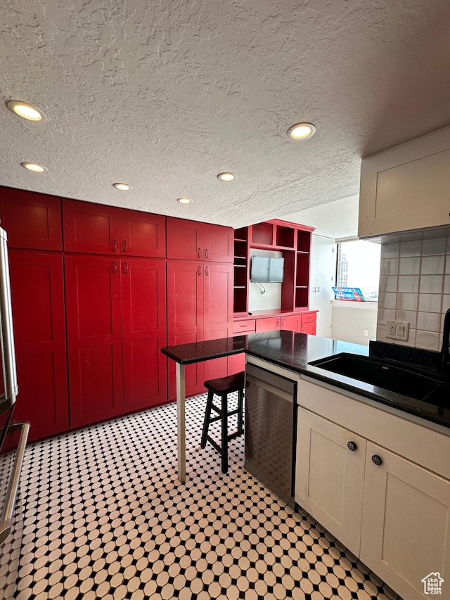 241 N Vine St W Unit 808W, Salt Lake City, UT 84103 - kitchen featuring dishwasher, dark countertops, a sink, recessed lighting, and a textured ceiling