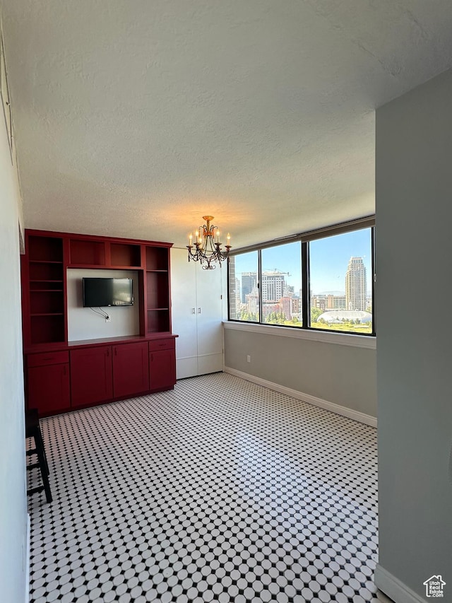 241 N Vine St W Unit 808W, Salt Lake City, UT 84103 - unfurnished dining area featuring a chandelier and a textured ceiling