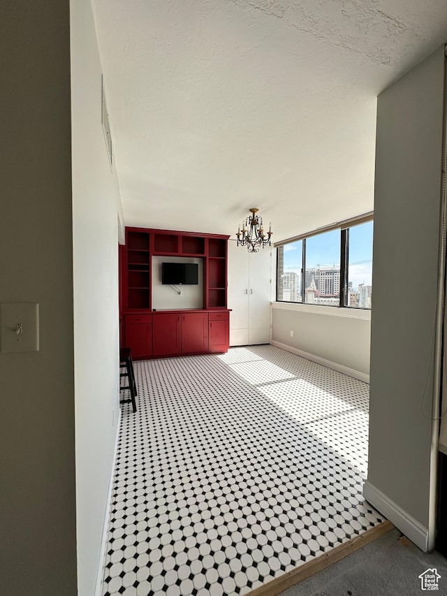 241 N Vine St W Unit 808W, Salt Lake City, UT 84103 - unfurnished living room featuring baseboards and a chandelier