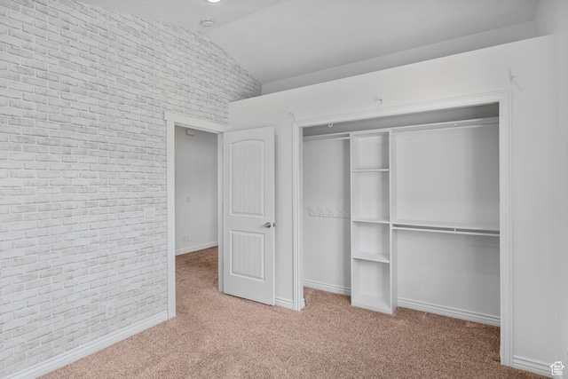 13226 S Cocomo Ct W, Herriman, UT 84096 - unfurnished bedroom featuring carpet, lofted ceiling, baseboards, a closet, and brick wall