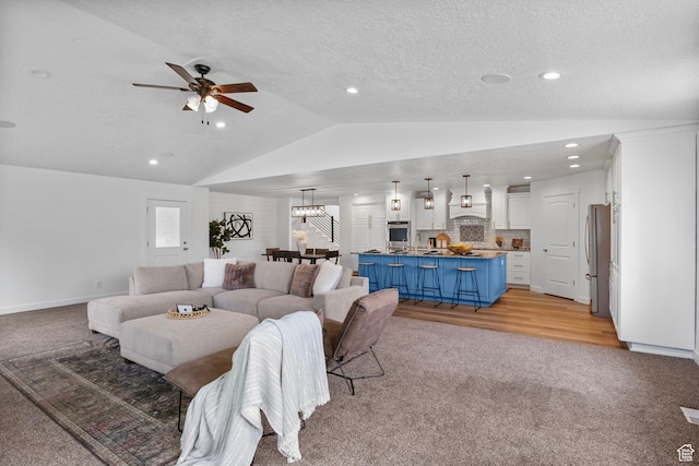13226 S Cocomo Ct W, Herriman, UT 84096 - living room with light carpet, vaulted ceiling, a ceiling fan, recessed lighting, and a chandelier