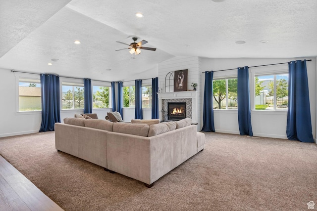 13226 S Cocomo Ct W, Herriman, UT 84096 - living room with a textured ceiling, baseboards, lofted ceiling, a tiled fireplace, and ceiling fan