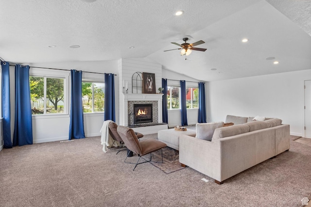 13226 S Cocomo Ct W, Herriman, UT 84096 - living area with vaulted ceiling, a textured ceiling, a glass covered fireplace, a ceiling fan, and carpet flooring