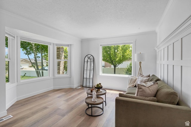 13226 S Cocomo Ct W, Herriman, UT 84096 - living area featuring ornamental molding, wood finished floors, a textured ceiling, and baseboards