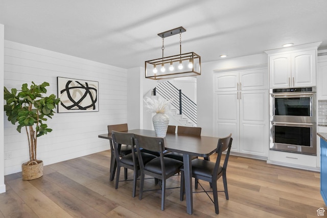 13226 S Cocomo Ct W, Herriman, UT 84096 - dining room with stairway, light wood-style flooring, recessed lighting, and wood walls