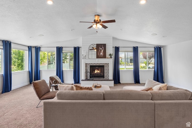 13226 S Cocomo Ct W, Herriman, UT 84096 - living room with lofted ceiling, a textured ceiling, light carpet, baseboards, and a tile fireplace