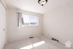 330 N 100 E, Centerfield, UT 84622 - unfurnished bedroom featuring baseboards and carpet flooring