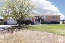 330 N 100 E, Centerfield, UT 84622 - view of front of house featuring a garage, a front lawn, and dirt driveway
