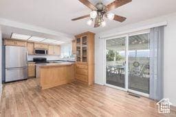 330 N 100 E, Centerfield, UT 84622 - kitchen featuring freestanding refrigerator, light wood-type flooring, a ceiling fan, glass insert cabinets, and a peninsula