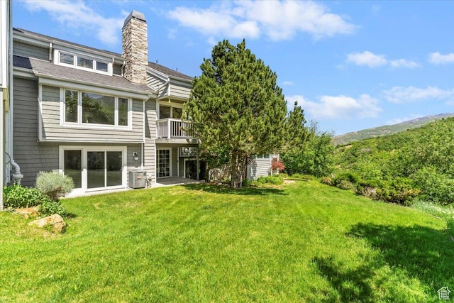 1825 S 1666th Dr E, Bountiful, UT 84010 - back of property with a chimney, a lawn, central AC, ac unit, and a shingled roof