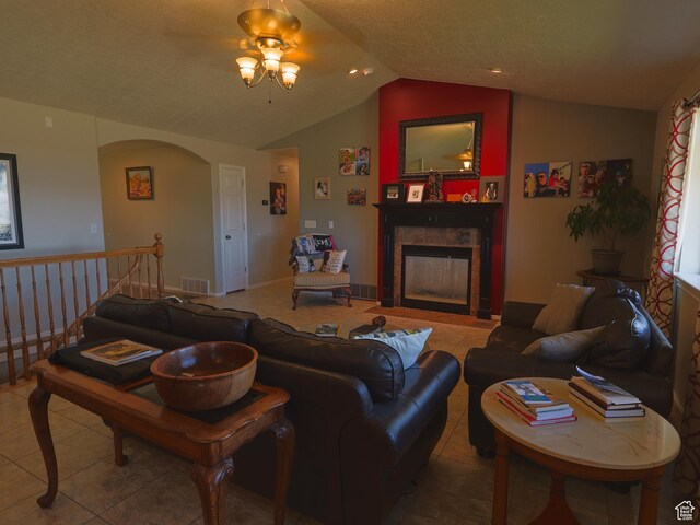 113 N 4950 W, West Point, UT 84015 - living room featuring vaulted ceiling, tile patterned floors, a fireplace, arched walkways, and a ceiling fan