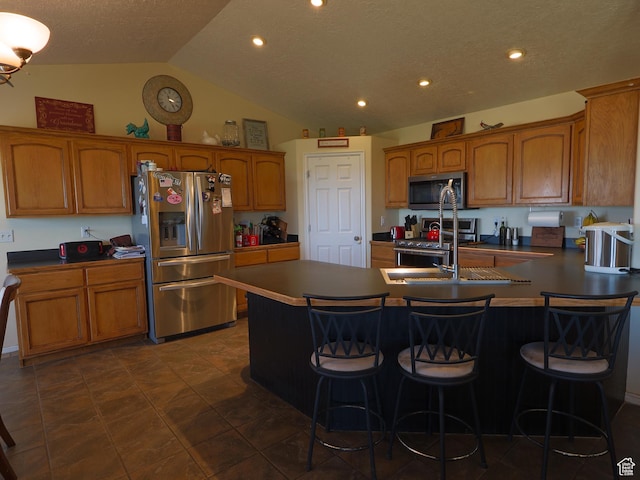 113 N 4950 W, West Point, UT 84015 - kitchen featuring appliances with stainless steel finishes, a sink, brown cabinets, lofted ceiling, and a breakfast bar
