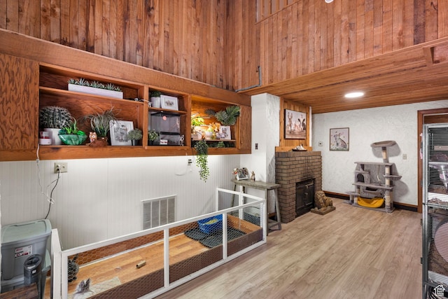 12 N Quiet Meadow Ln, Mapleton, UT 84664 - miscellaneous room with wood finished floors, a fireplace, and wooden walls