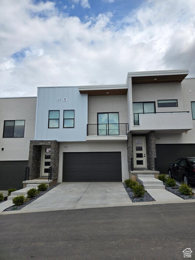 187 E 210 N Unit 7, North Salt Lake, UT 84054 - contemporary home with an attached garage, stone siding, a balcony, and stucco siding