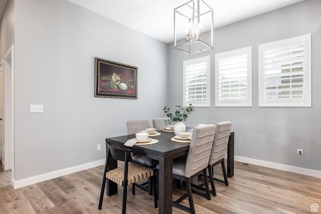 5067 W Beach Comber Way S, South Jordan, UT 84009 - dining area with light wood finished floors, healthy amount of natural light, a chandelier, and baseboards