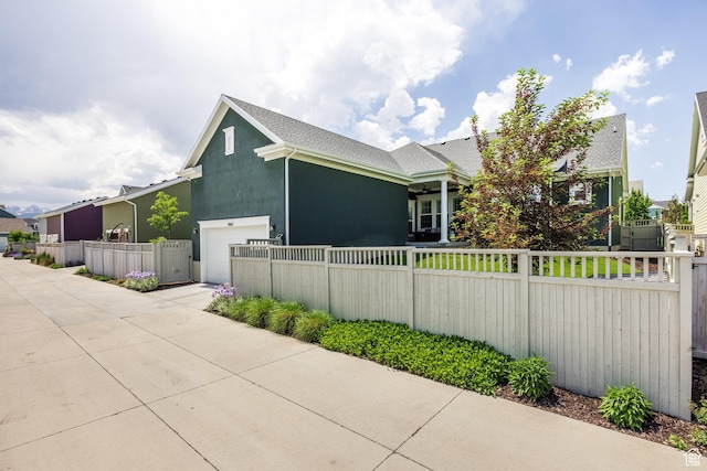 5067 W Beach Comber Way S, South Jordan, UT 84009 - view of property exterior with a fenced front yard, an attached garage, stucco siding, and driveway