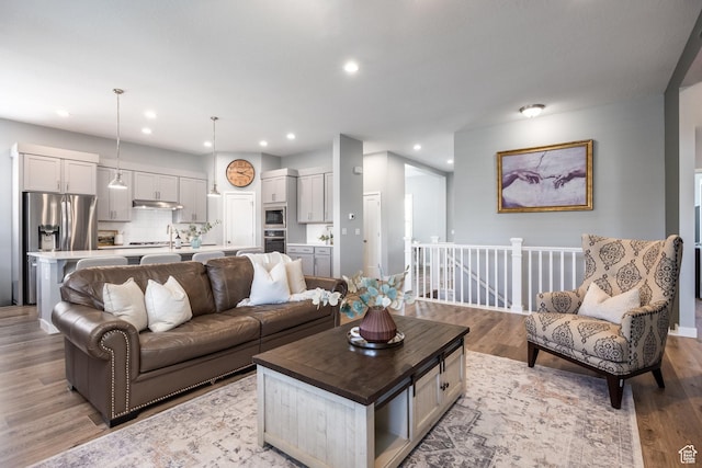 5067 W Beach Comber Way S, South Jordan, UT 84009 - living room featuring light wood-style flooring and recessed lighting