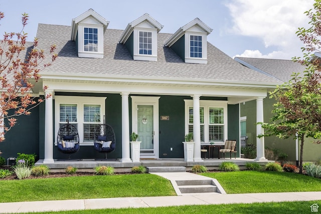 5067 W Beach Comber Way S, South Jordan, UT 84009 - view of front of home featuring a porch, a shingled roof, and a front lawn