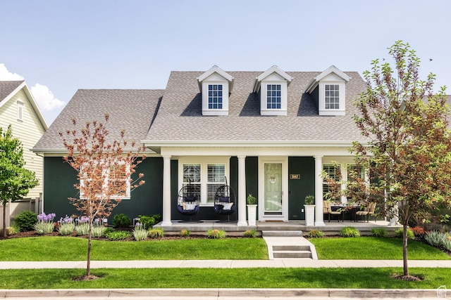 5067 W Beach Comber Way S, South Jordan, UT 84009 - cape cod home featuring covered porch, a shingled roof, and a front lawn