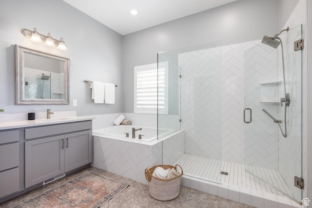 5067 W Beach Comber Way S, South Jordan, UT 84009 - bathroom with vanity, a garden tub, a shower stall, and tile patterned floors
